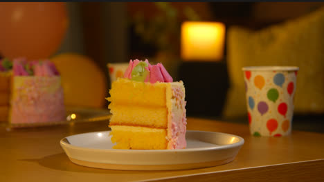 Slice-Of-Party-Celebration-Cake-For-Birthday-Decorated-With-Icing-On-Table-At-Home-7